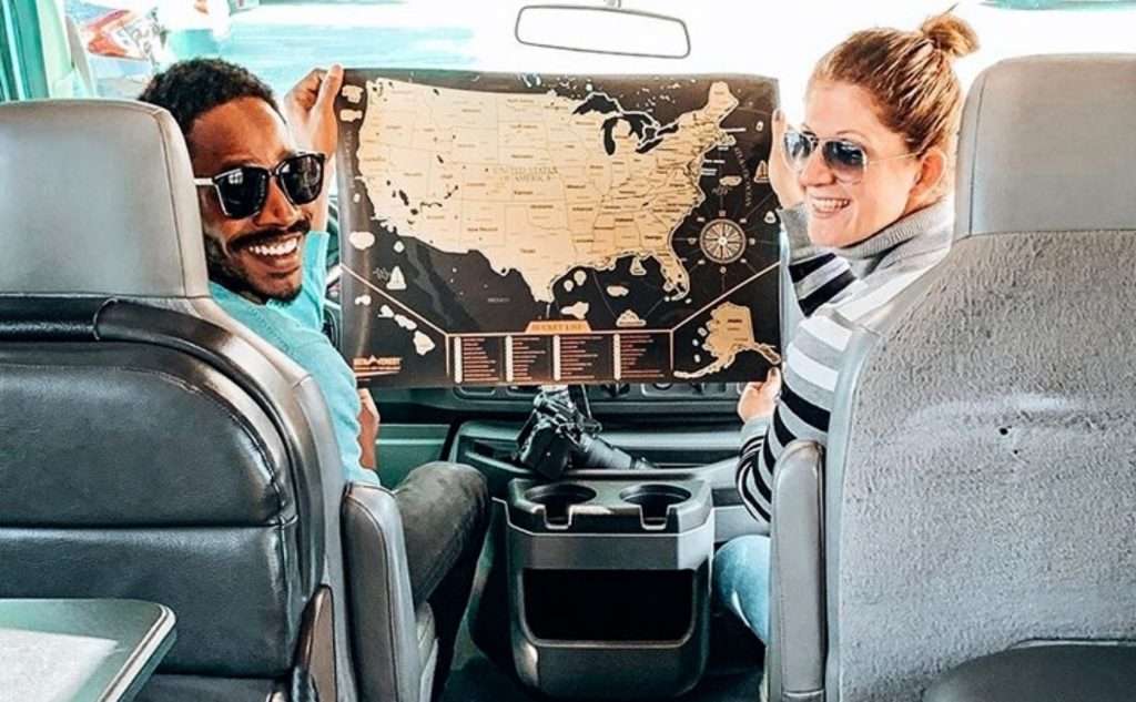 Couple holding a map of America in the RV