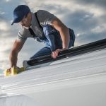 man cleaning RV roof